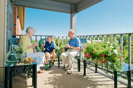 A heartwarming family gathering on a sunny balcony, enjoying each other's company.