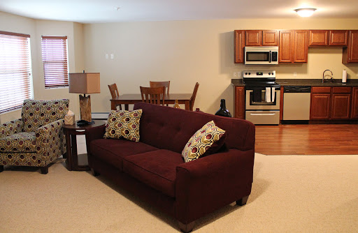 A cozy living room area with a comfortable sofa and an integrated kitchen.
