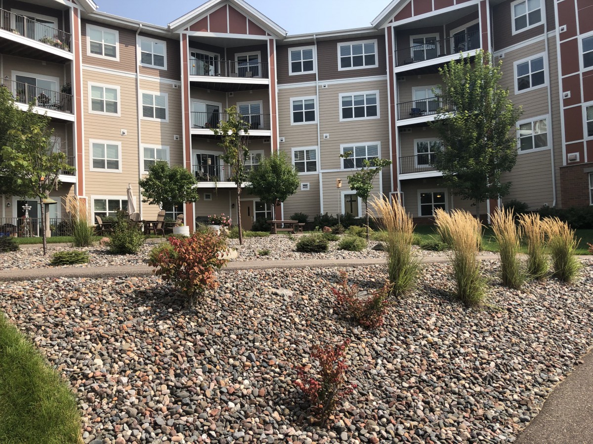 A multistory apartment building with landscaped grounds.
