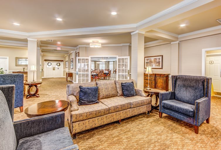 A cozy living room with sofas and armchairs arranged in a welcoming layout.