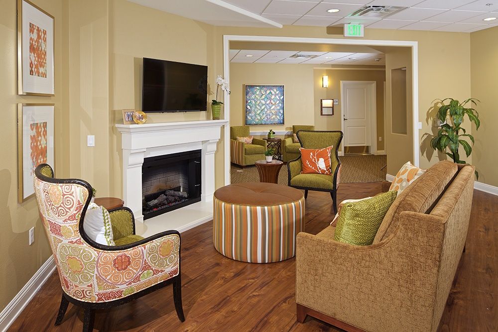 A cozy and modern living room with a fireplace and comfortable seating.