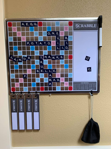 A Scrabble board displaying an ongoing game with various letter tiles placed strategically.