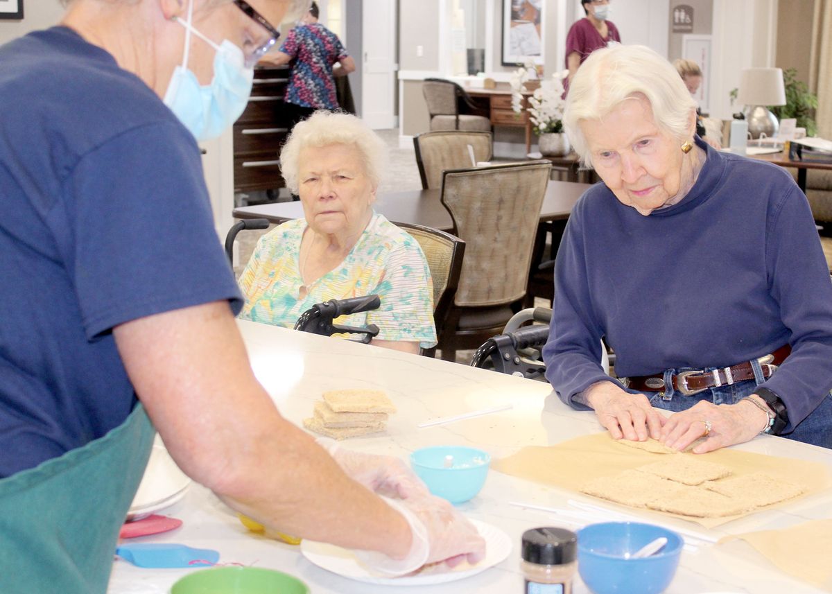 Elderly residents participating in a cooking activity at a care home.