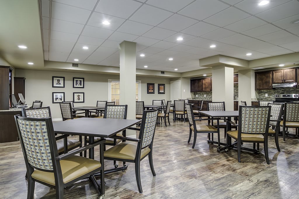 An empty dining area with tables and chairs, well-lit and decorated.