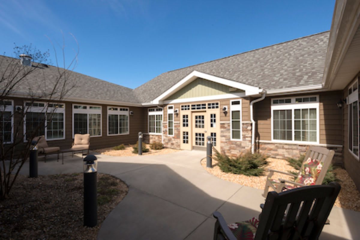 A courtyard view of a residential building with brick exterior and multiple windows.