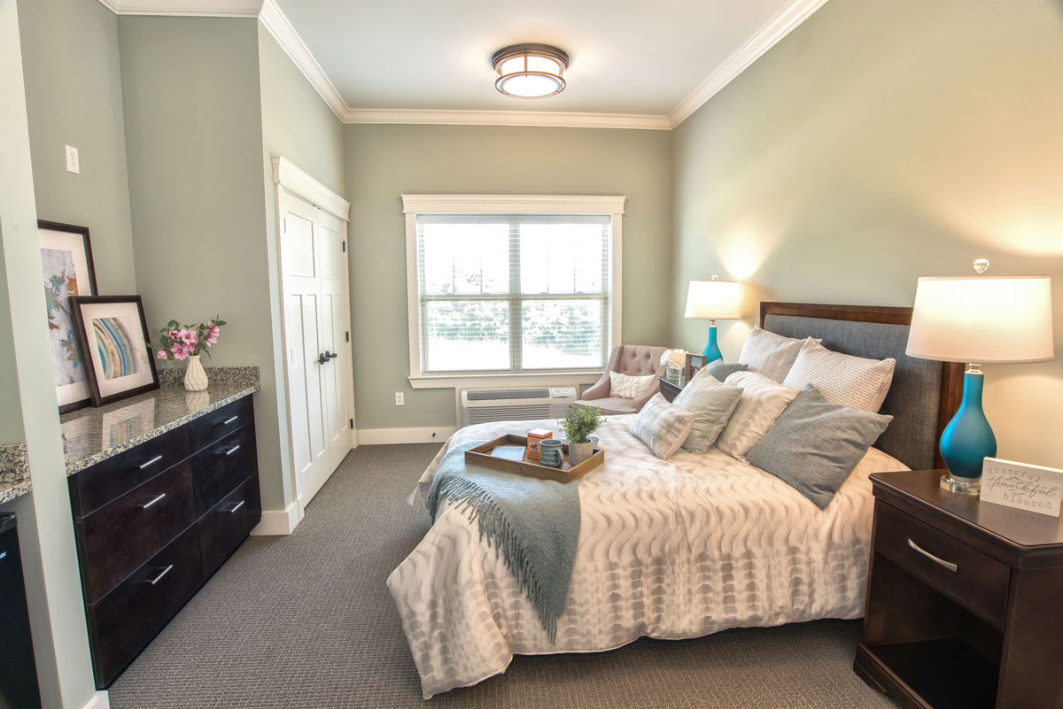 A cozy and modern bedroom interior with elegant decor and natural lighting.