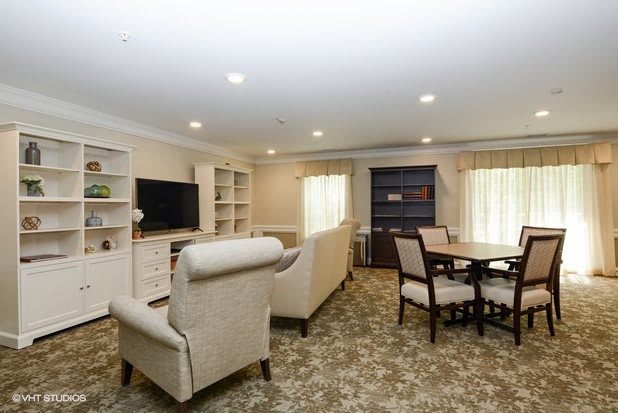A cozy living room with comfortable seating, a television, and a dining area.