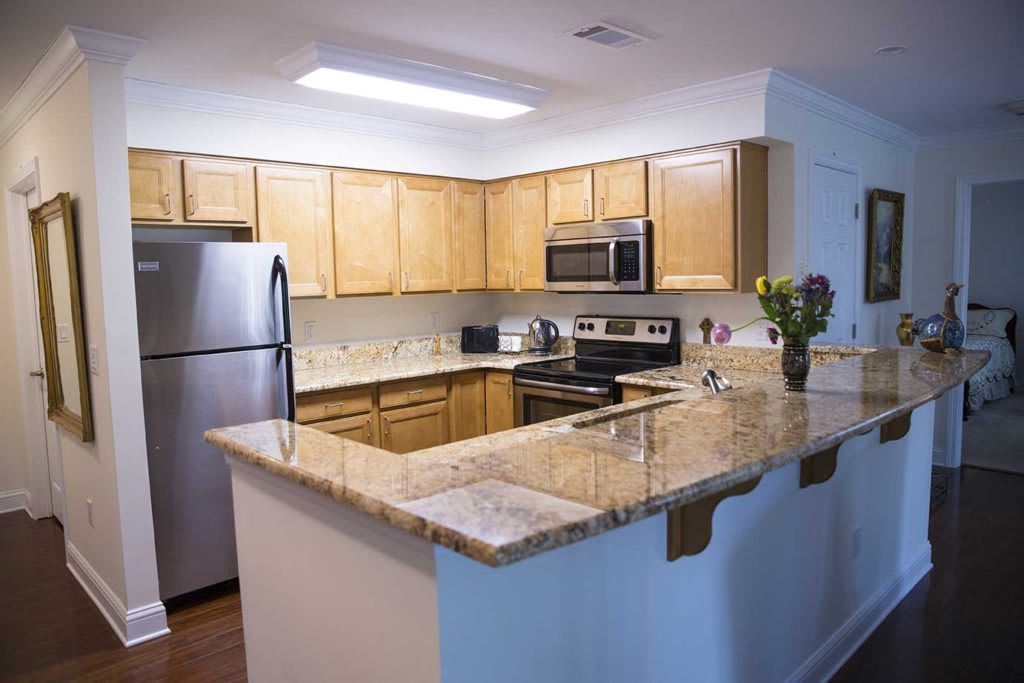 A modern kitchen with granite countertops and stainless steel appliances.