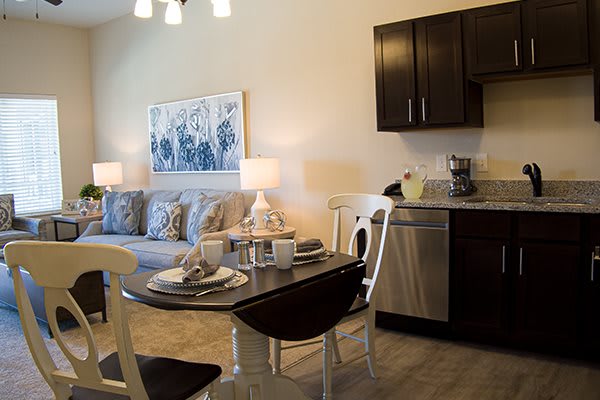 A modern open-concept living and kitchen area with a cozy dining setup.