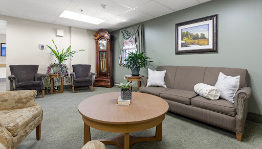 A cozy living room featuring comfortable seating and a stylish coffee table with greenery.