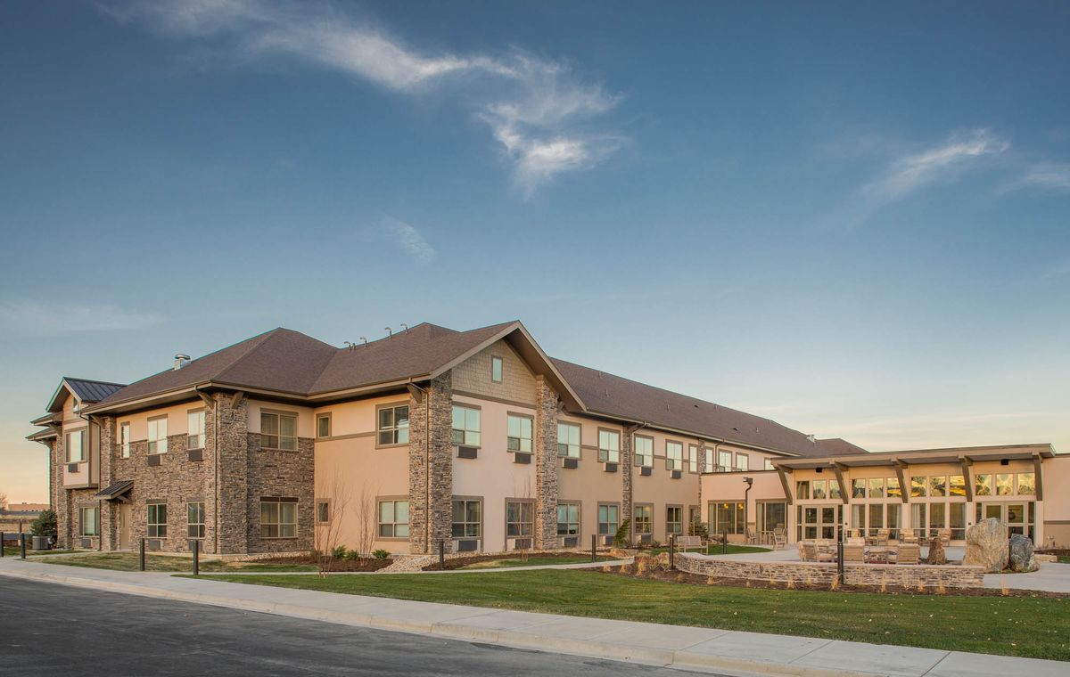A modern residential building with a well-maintained exterior under a clear blue sky.