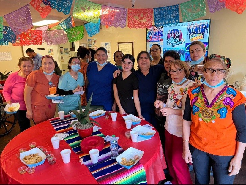 A group of people enjoying a festive celebration with colorful decorations and food.