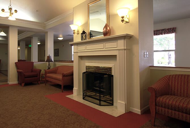 A cozy living room with a fireplace and comfortable seating.