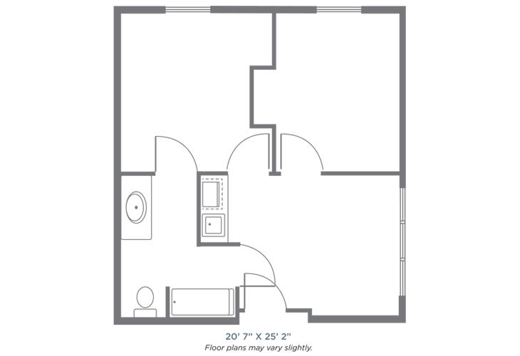 A simple floor plan of an apartment with a bathroom, kitchen, and main living area.