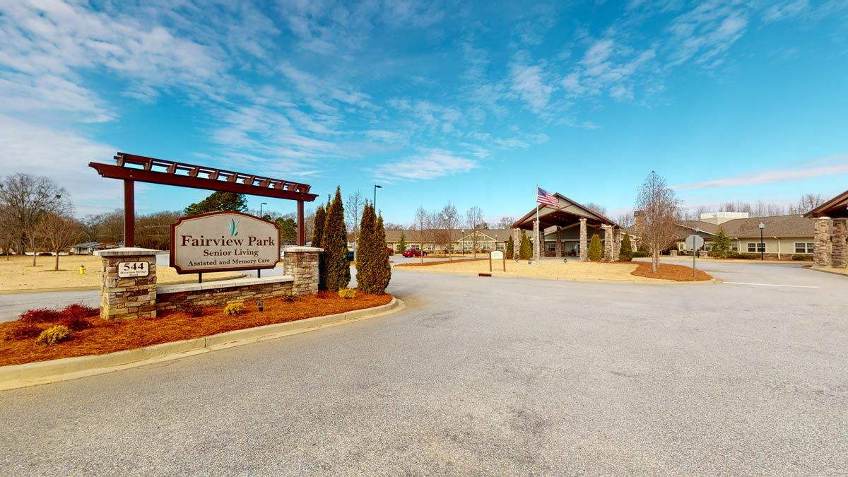 Entrance to a park with signage and a clear blue sky.
