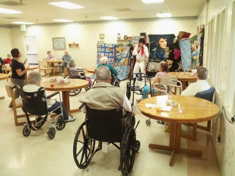 Elderly residents in a nursing home engage in communal activities.