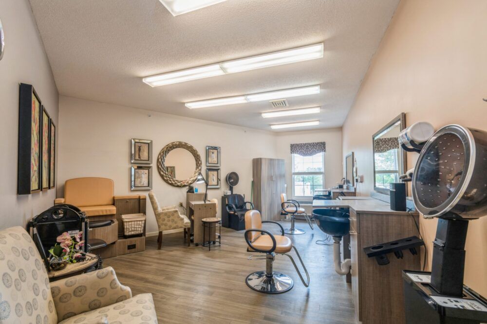A well-lit hair salon with stylish chairs and mirrors.