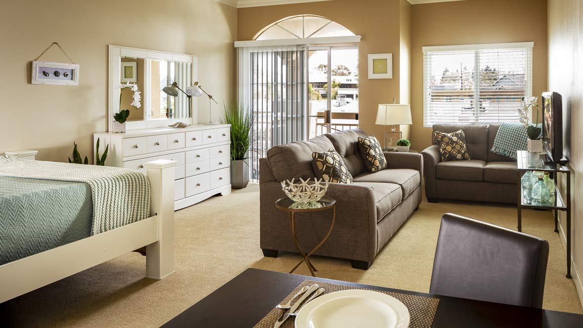 A cozy living room with a modern sofa, dining area, and stylish decor.