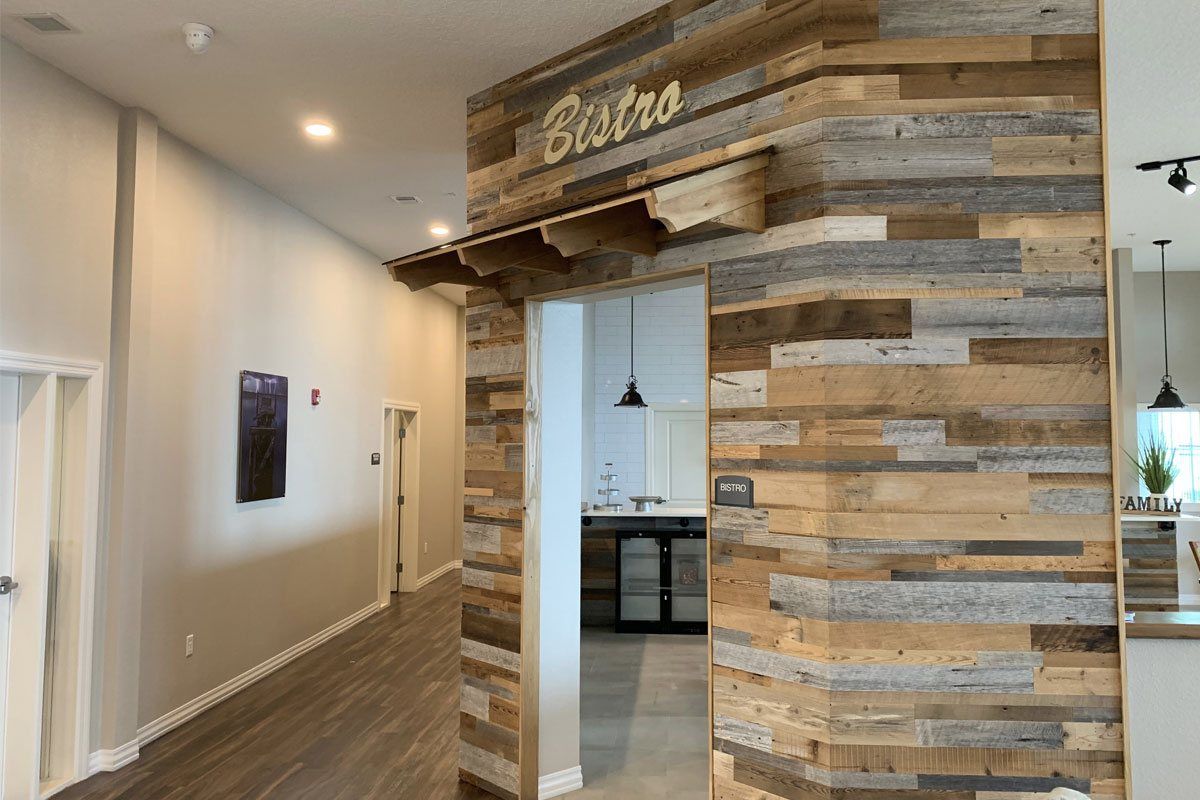 A cozy bistro entrance with rustic wooden decor and modern lighting.