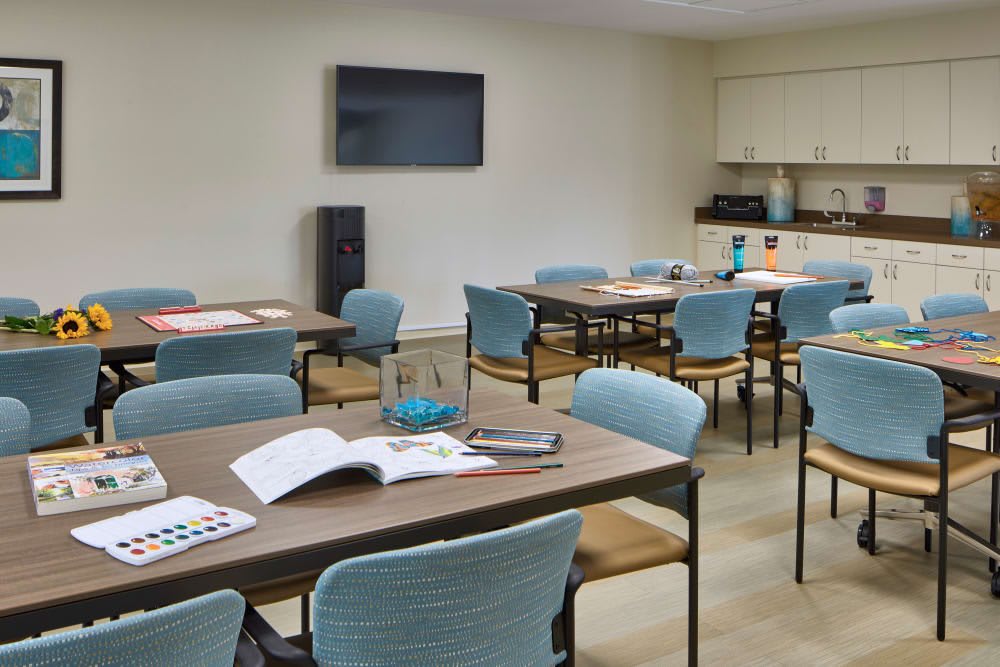 A classroom setup with tables, chairs, and study materials.