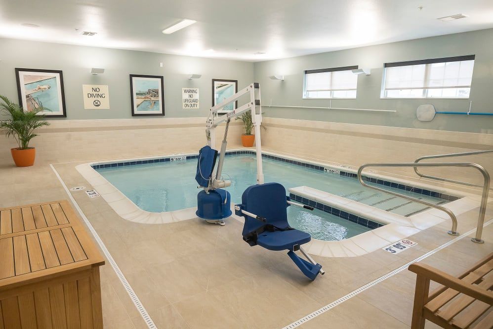 An indoor therapy pool equipped with accessibility lifts.