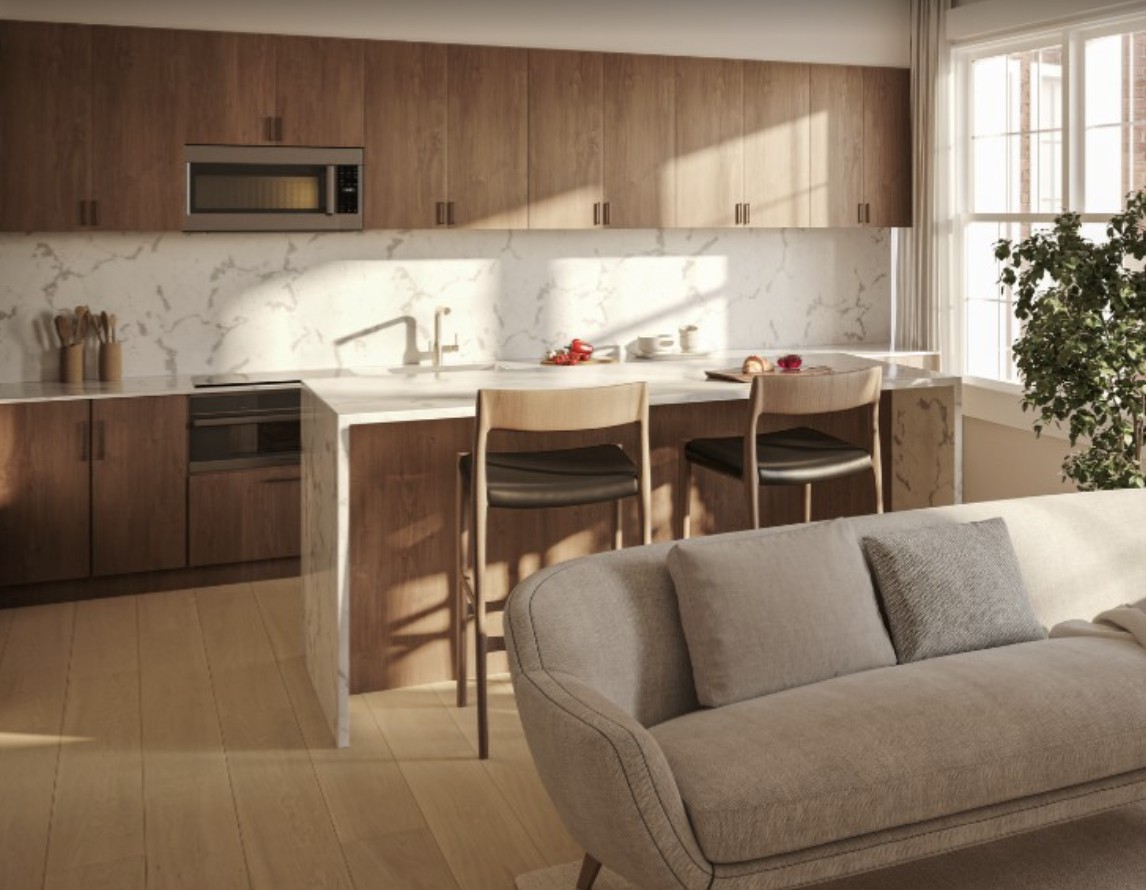 A modern, minimalist kitchen with a central island and wood cabinetry.