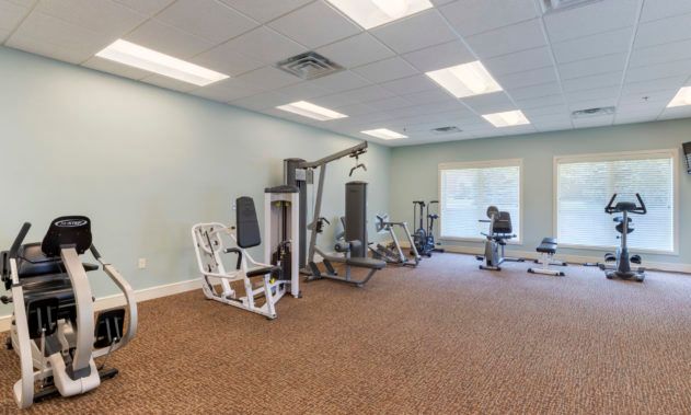 A well-lit gym with various exercise equipment, ready for workouts.