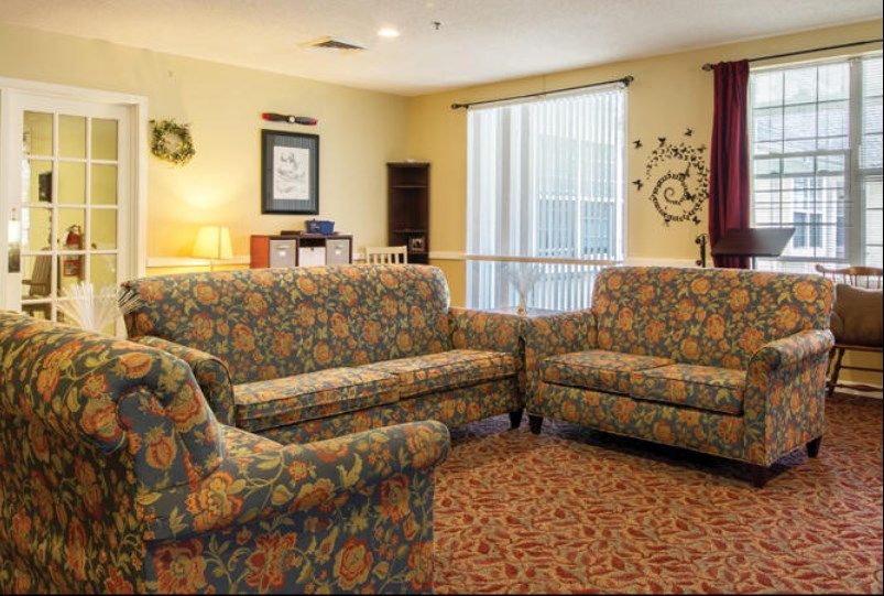 Cozy living room with patterned sofas and warm lighting.