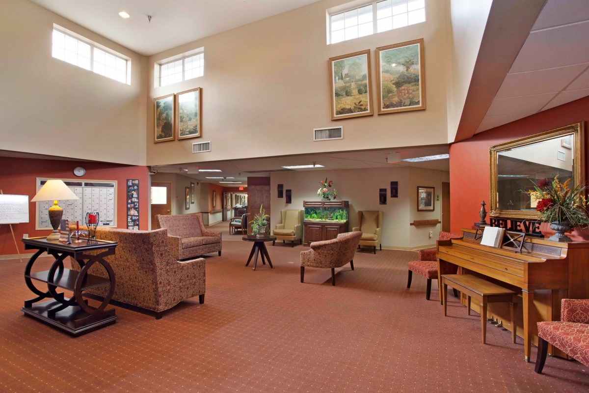 A spacious lobby with comfortable seating and decorative artwork on the walls.