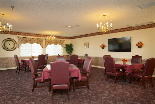 A cozy dining area featuring elegant furnishings and warm lighting, perfect for gatherings.