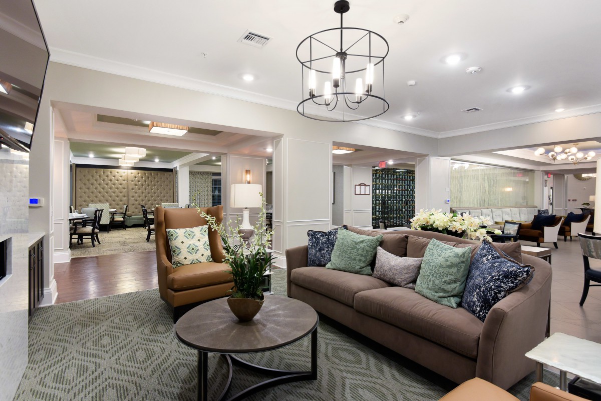 A modern living room with comfortable seating and elegant lighting.