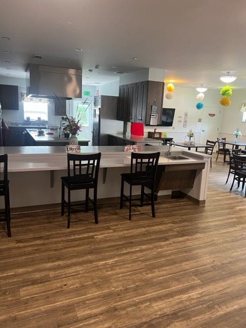 A modern kitchen and dining area with a sleek counter and wooden flooring.