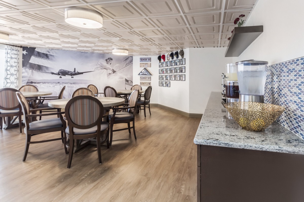 A modern dining area with elegant chairs and tables, featuring aviation-themed wall art.