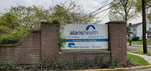 A sign for Alaris Health, a specialty hospital offering comprehensive healthcare services.