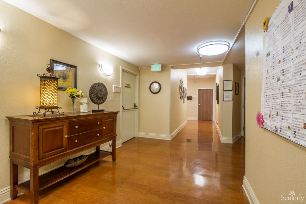 A well-lit hallway with wooden floors and decorative furnishings.