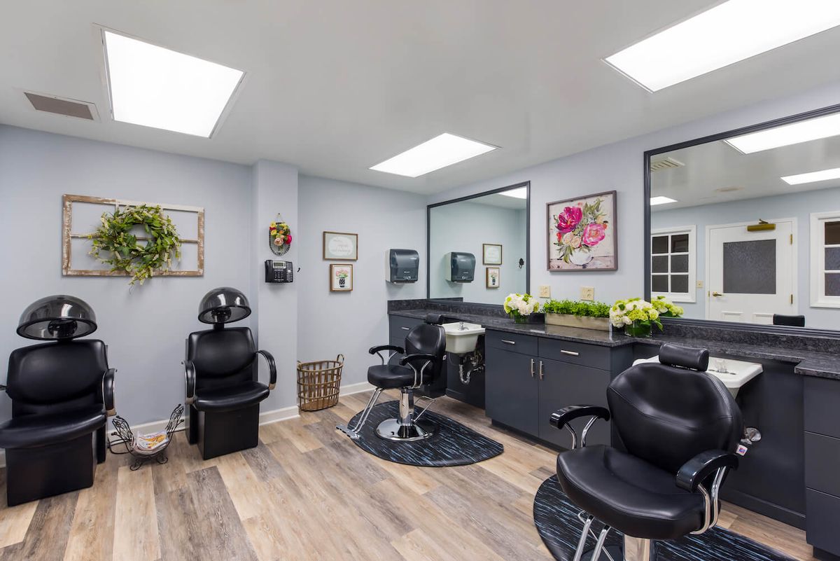 A modern hair salon with styling chairs and mirrors.