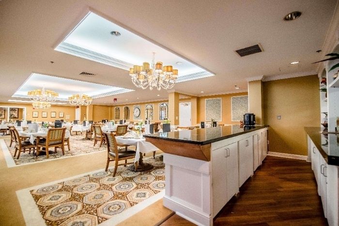 An elegant dining room with chandeliers and a classic interior design.