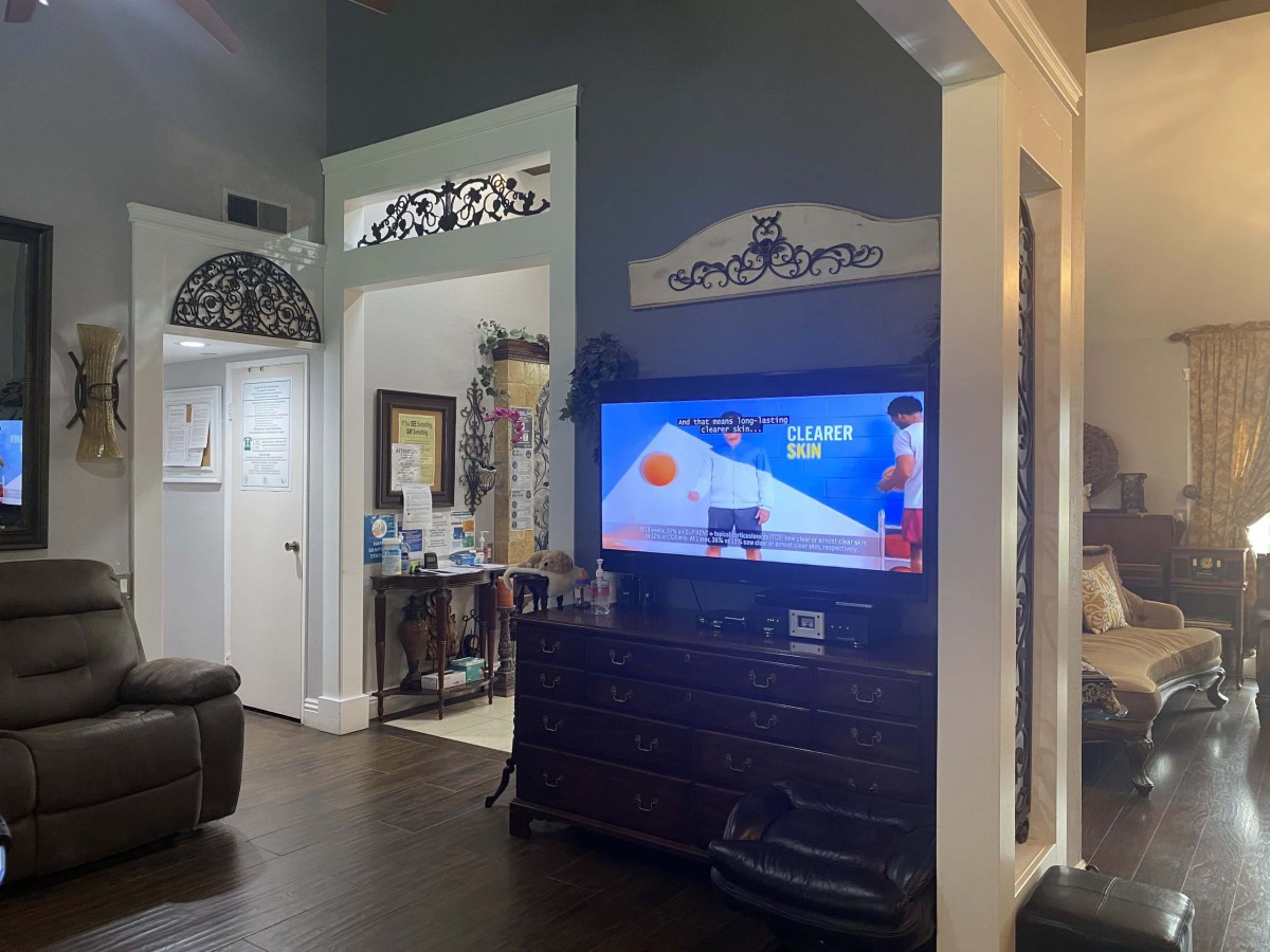 A cozy living room with a television and home decor.