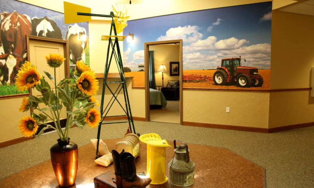 A country-themed room with sunflowers and a tractor mural on the wall.