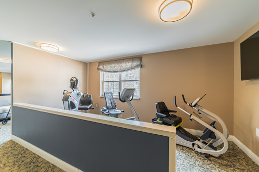 A modern fitness center featuring various workout machines in a well-lit indoor space.