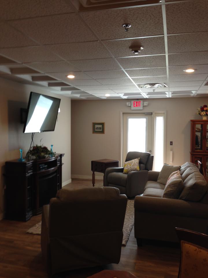 A cozy living room with a sofa, television, and modern decor.