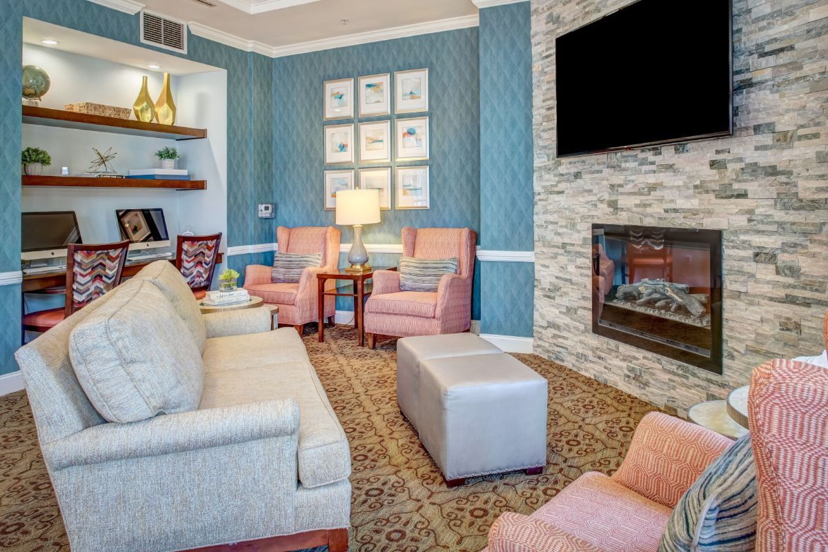 A cozy living room with elegant furniture, a fireplace, and a mounted television.