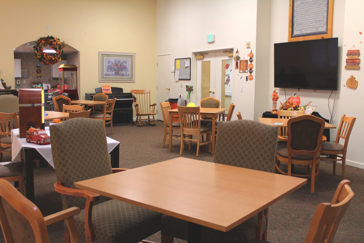 A cozy community space with tables and chairs arranged for gatherings.