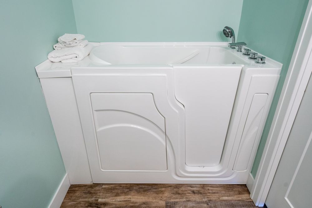 A walk-in bathtub with accessible features, designed for safety and ease of use.