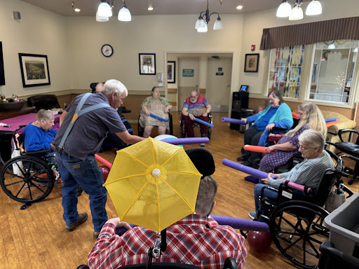 Seniors participating in a fun exercise session at a community center.
