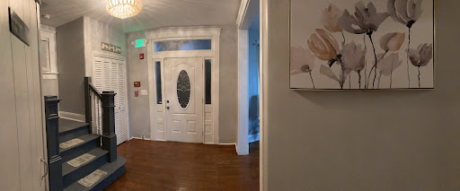 A welcoming entrance featuring a decorative door and elegant wooden flooring.
