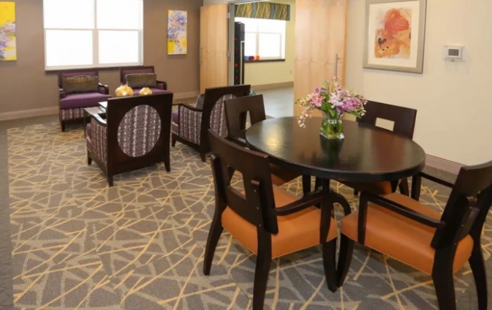 A modern living room with a dining table and comfortable seating area.