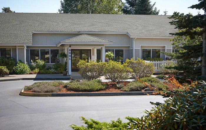 A residential building with well-maintained landscaping and greenery.