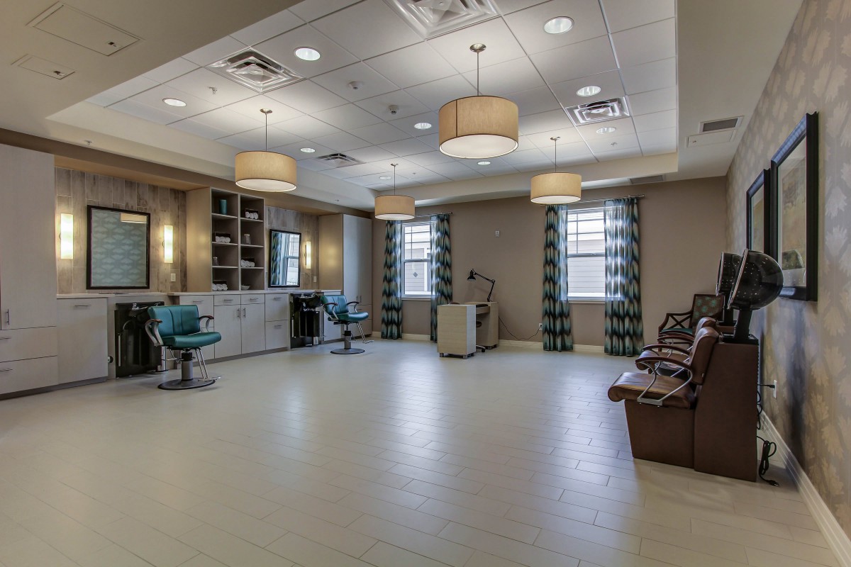 A modern salon interior with stylish furnishings and ample lighting.