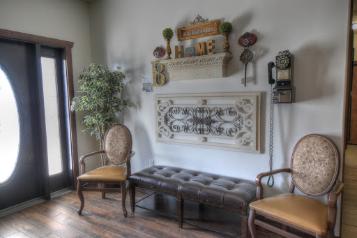 A cozy waiting area featuring vintage decor, comfortable seating, and decorative wall elements.